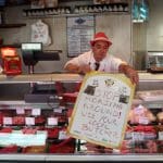 A Scottish butcher putting out a sign