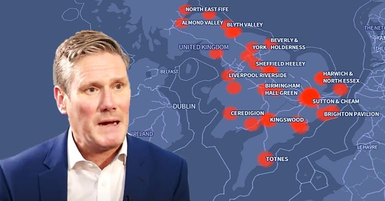 Keir Starmer in front of an interactive map