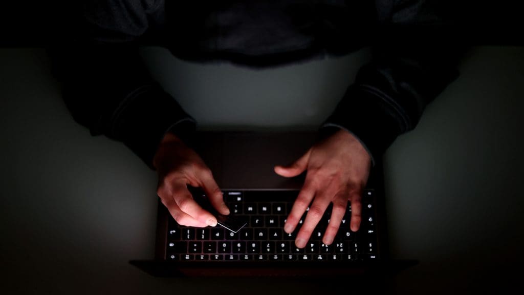 Hands typing on a keyboard