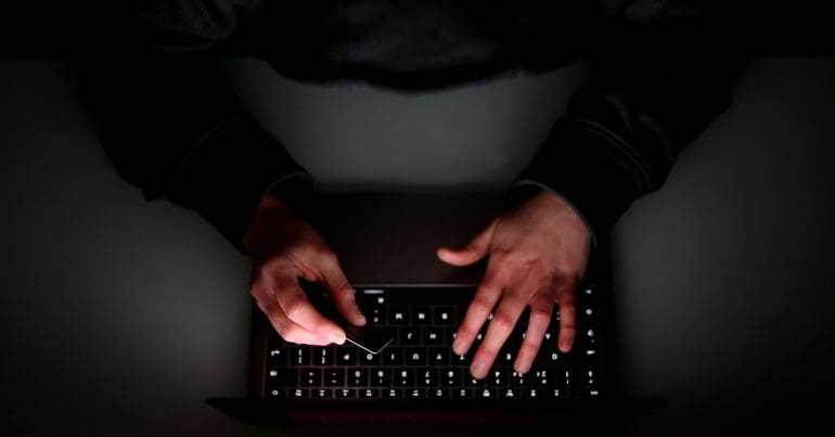 Hands typing on a keyboard