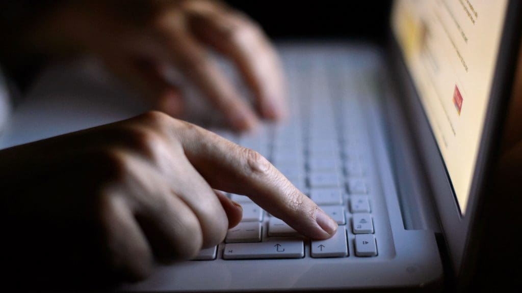 Hands typing on a keyboard