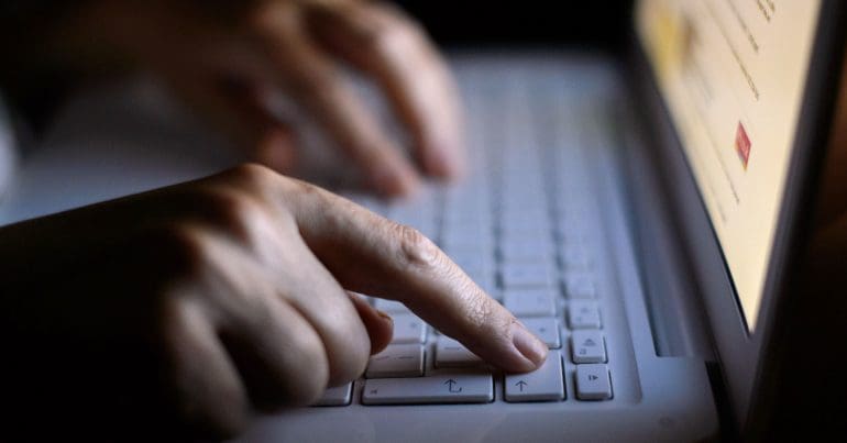 Hands typing on a keyboard