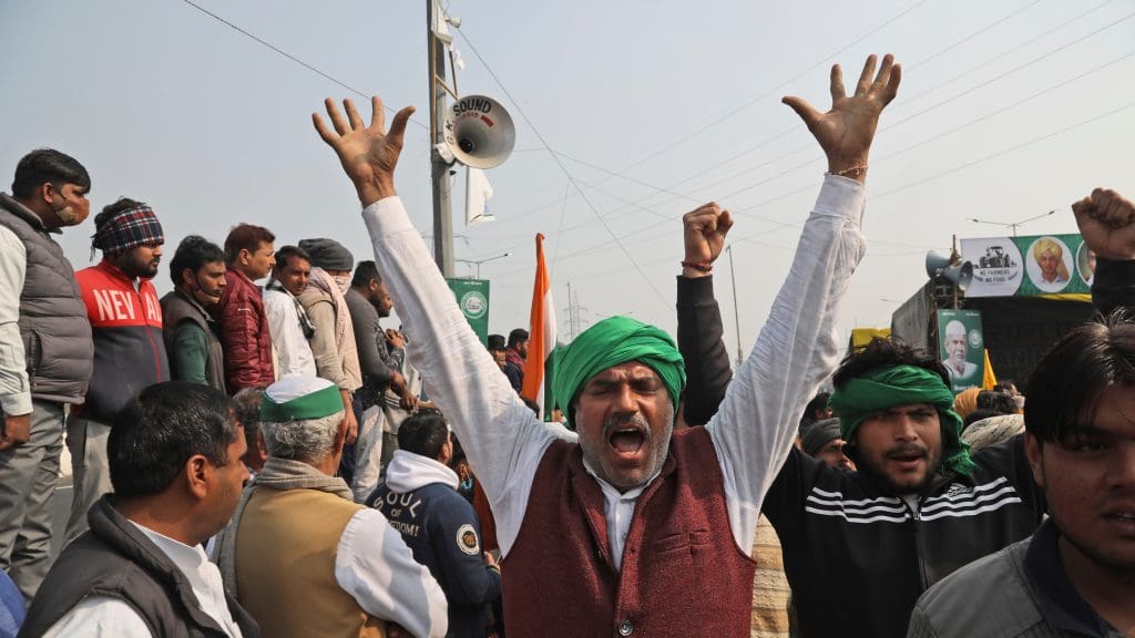 An Indian protester raising his hands