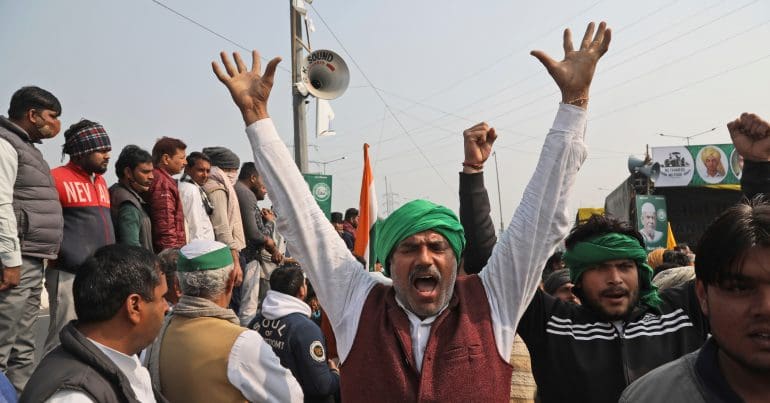 An Indian protester raising his hands