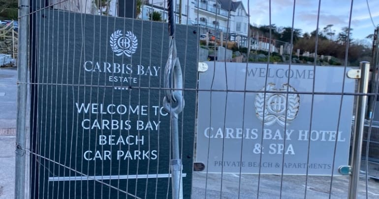 Carbis Bay hotel sign in front of a fence