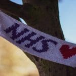 A knitted flag reading "NHS"
