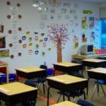A classroom with a logo of a secret teacher