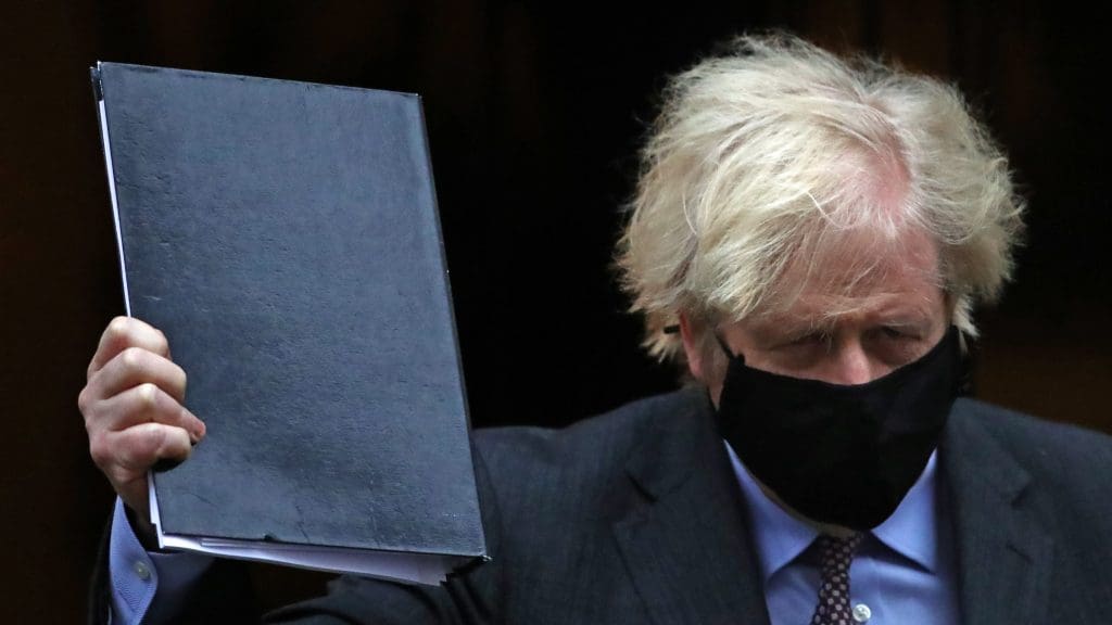 Boris Johnson in a black mask holding up a black folder