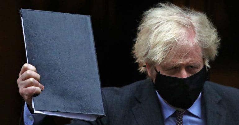Boris Johnson in a black mask holding up a black folder