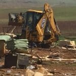 A Jcb machine being used during demolitions in Humsa