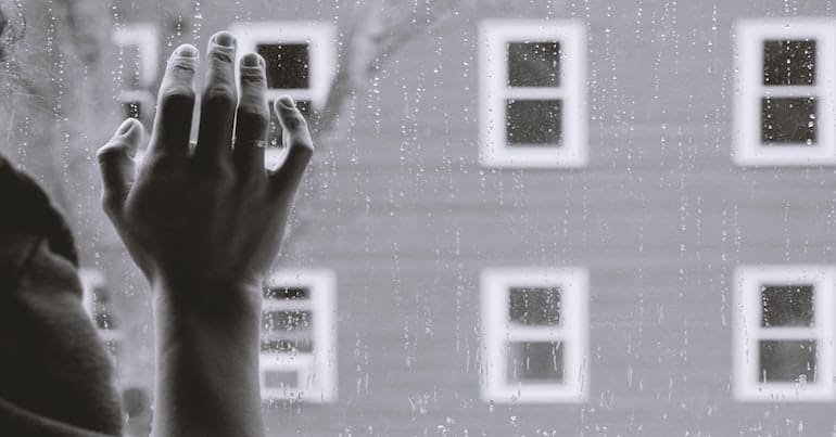 A person's hand on a window
