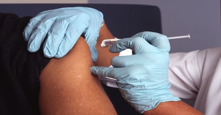 nurse administers a vaccine