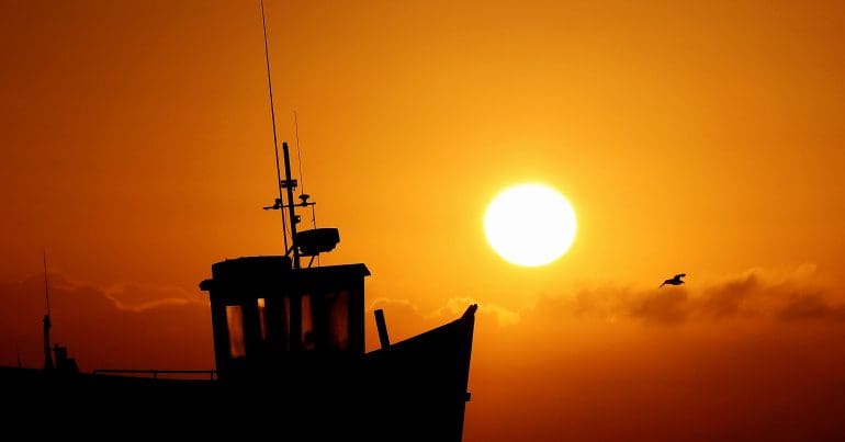The sun going down on a British fishing boat