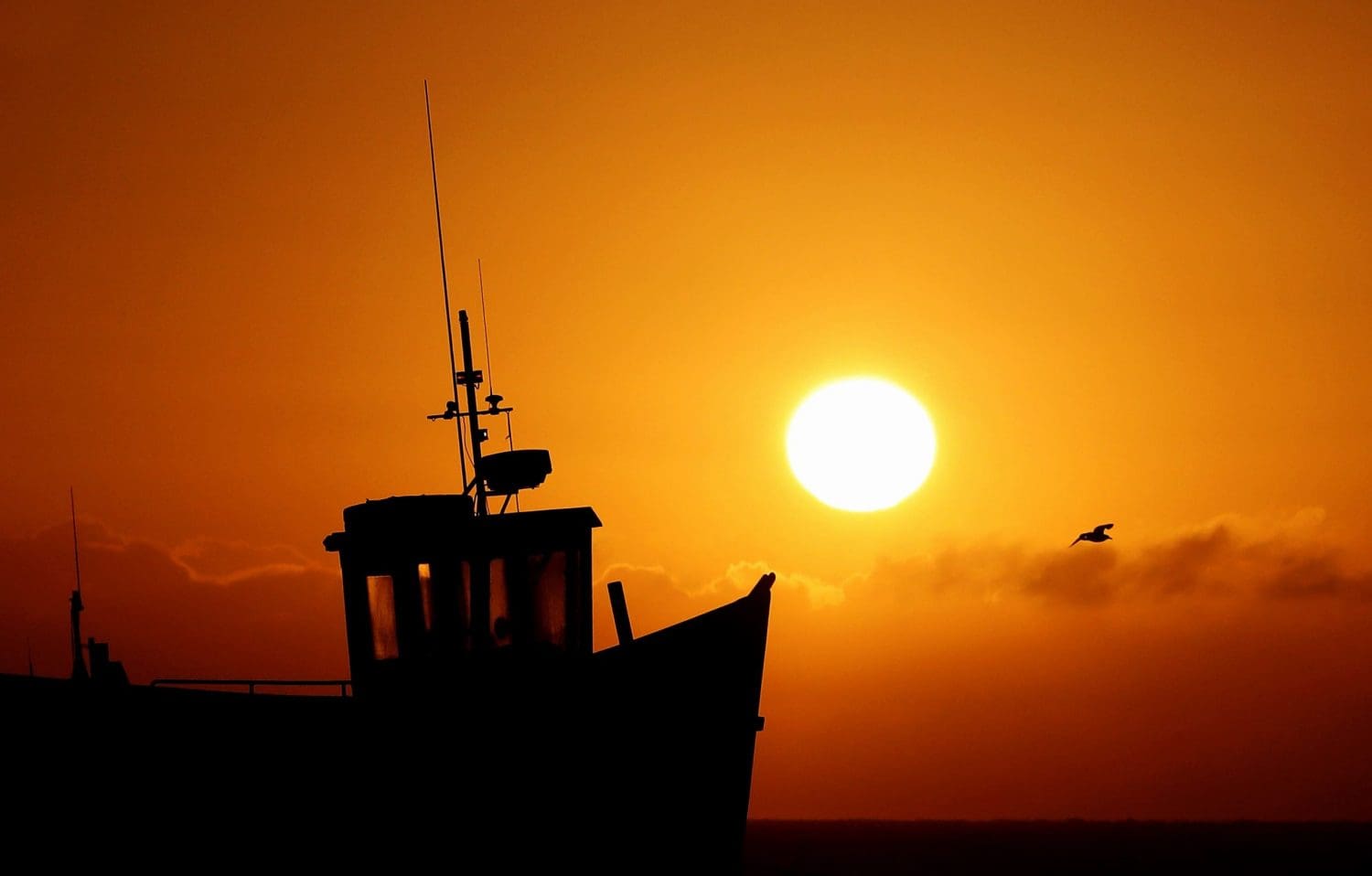 The sun going down on a British fishing boat