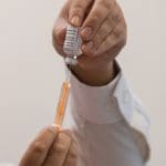 A syringe and a bottle of vaccine