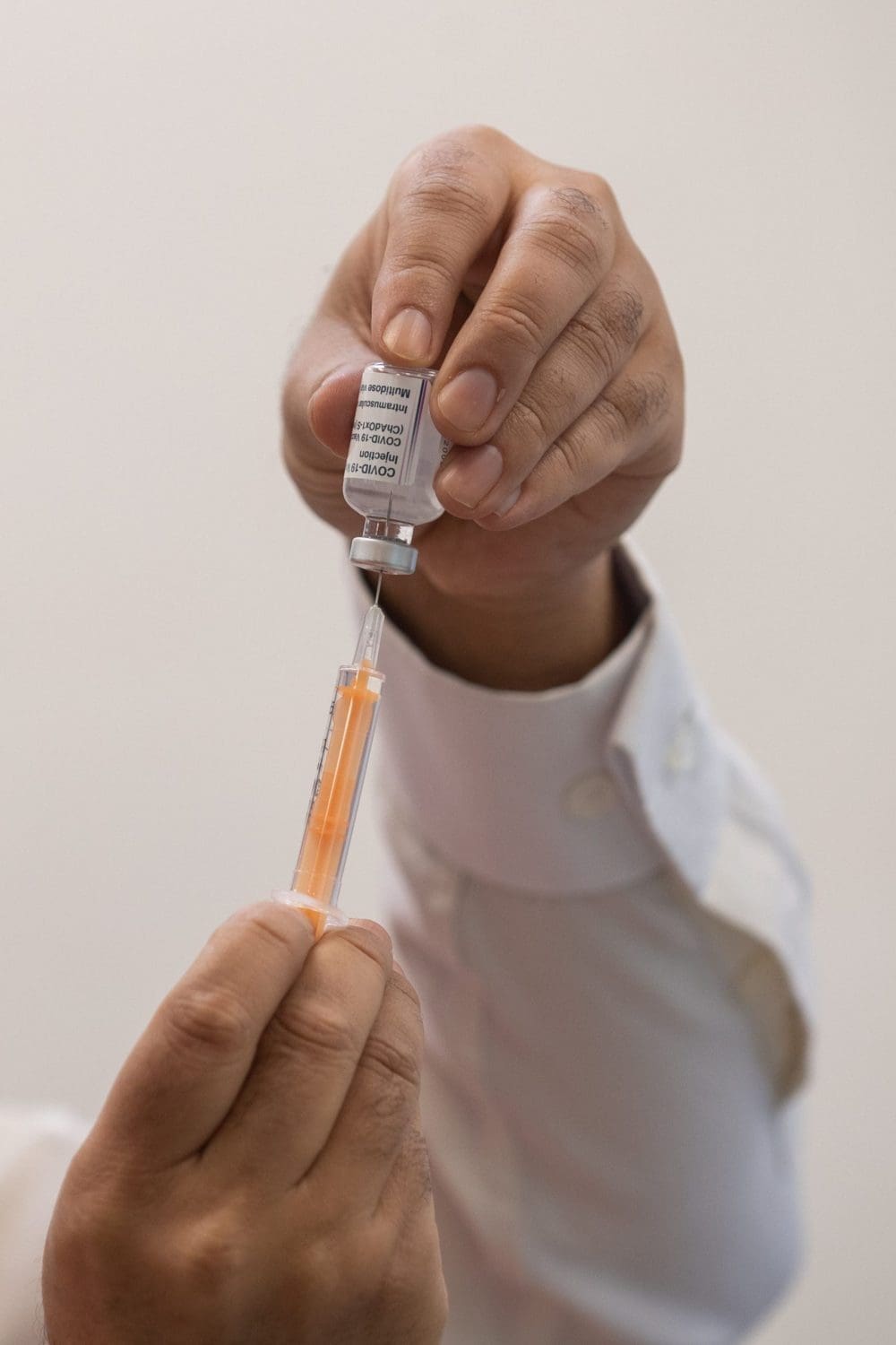 A syringe and a bottle of vaccine