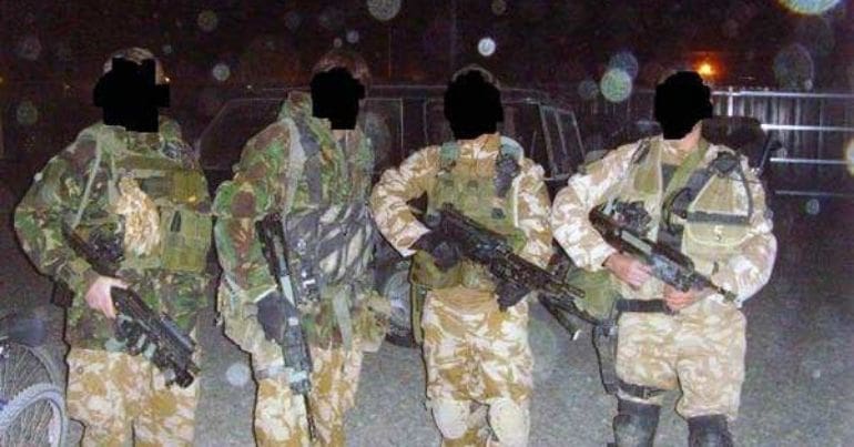 Soldiers with their faces blacked out