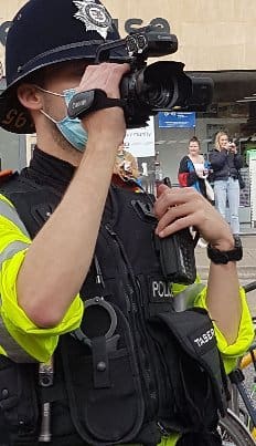 The police filming protesters at College Green