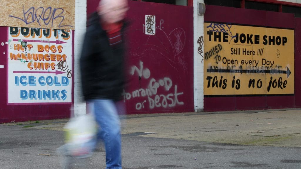 A blurry man walking down the street