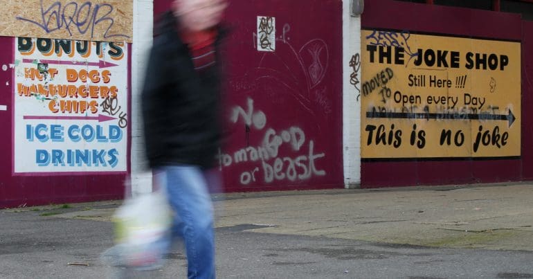 A blurry man walking down the street