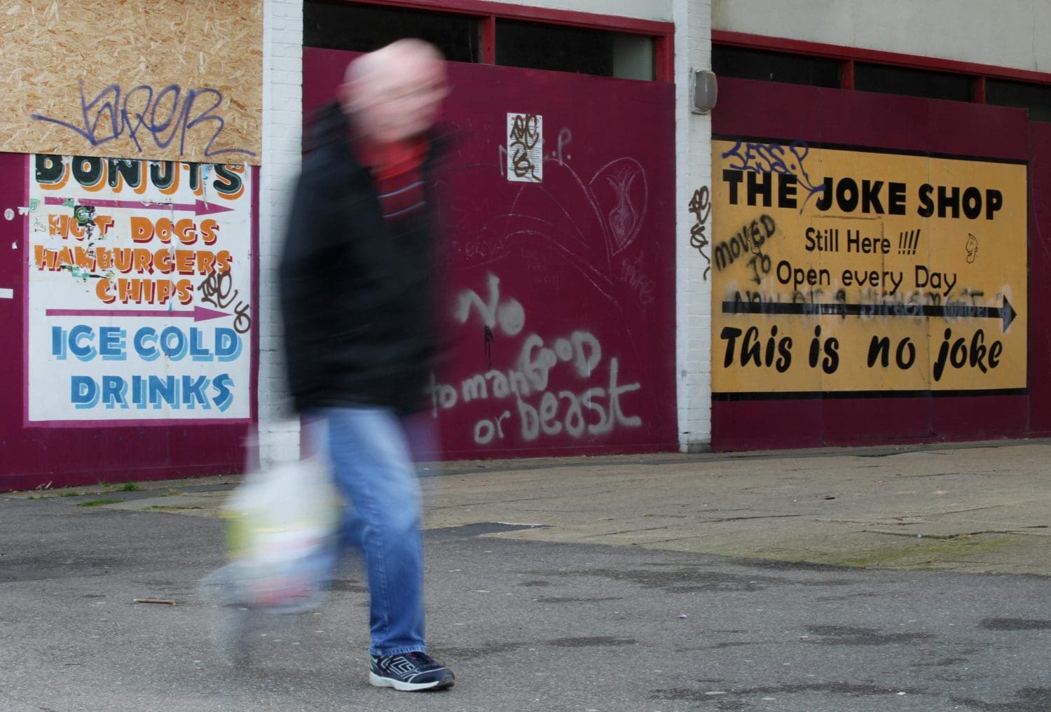 A blurry man walking down the street