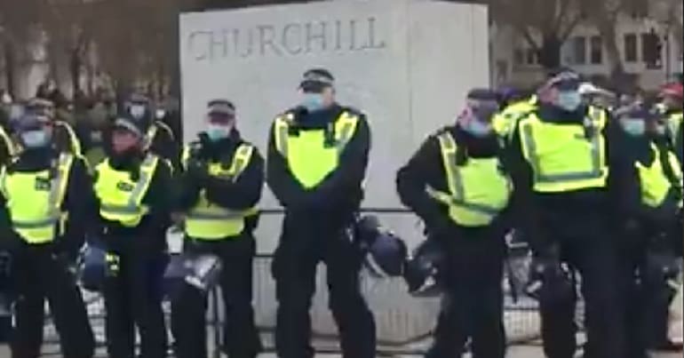 Police protecting the Churchill statue as an example of fascism