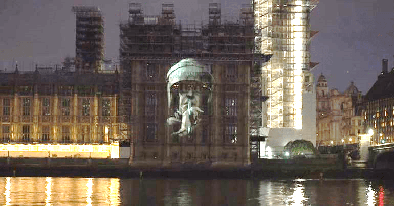 Riot cop image projected on to parliament