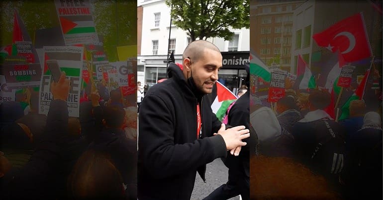 Lowkey against a backdrop of the Free Palestine demo in London
