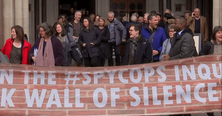 Protesters holding banner that says 'The Spycops Inquiry...Wall of Silence"