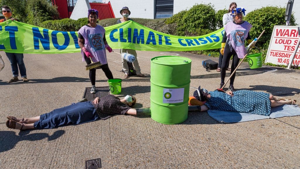 Climate protestors locked on to a barrel