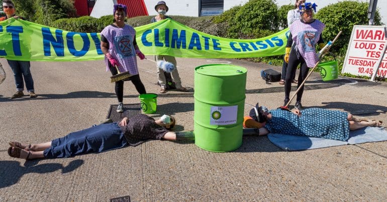 Climate protestors locked on to a barrel