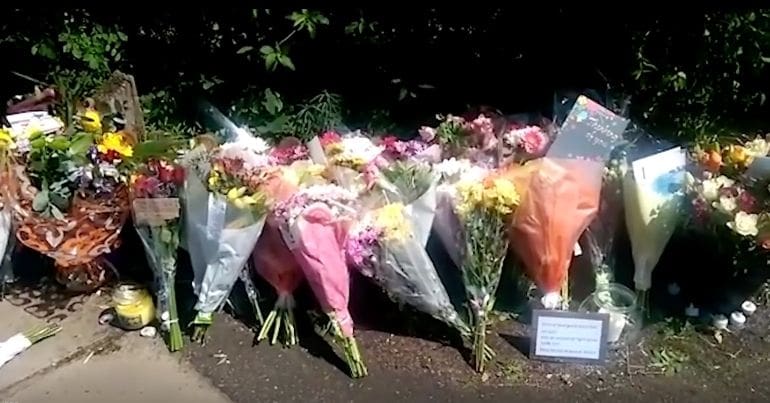 Flowers at the scene of Dea-John Reid's murder