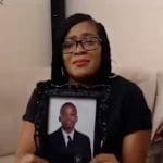 Osime Brown's mother holds a photo of her son