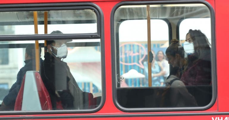People wearing masks on a bus