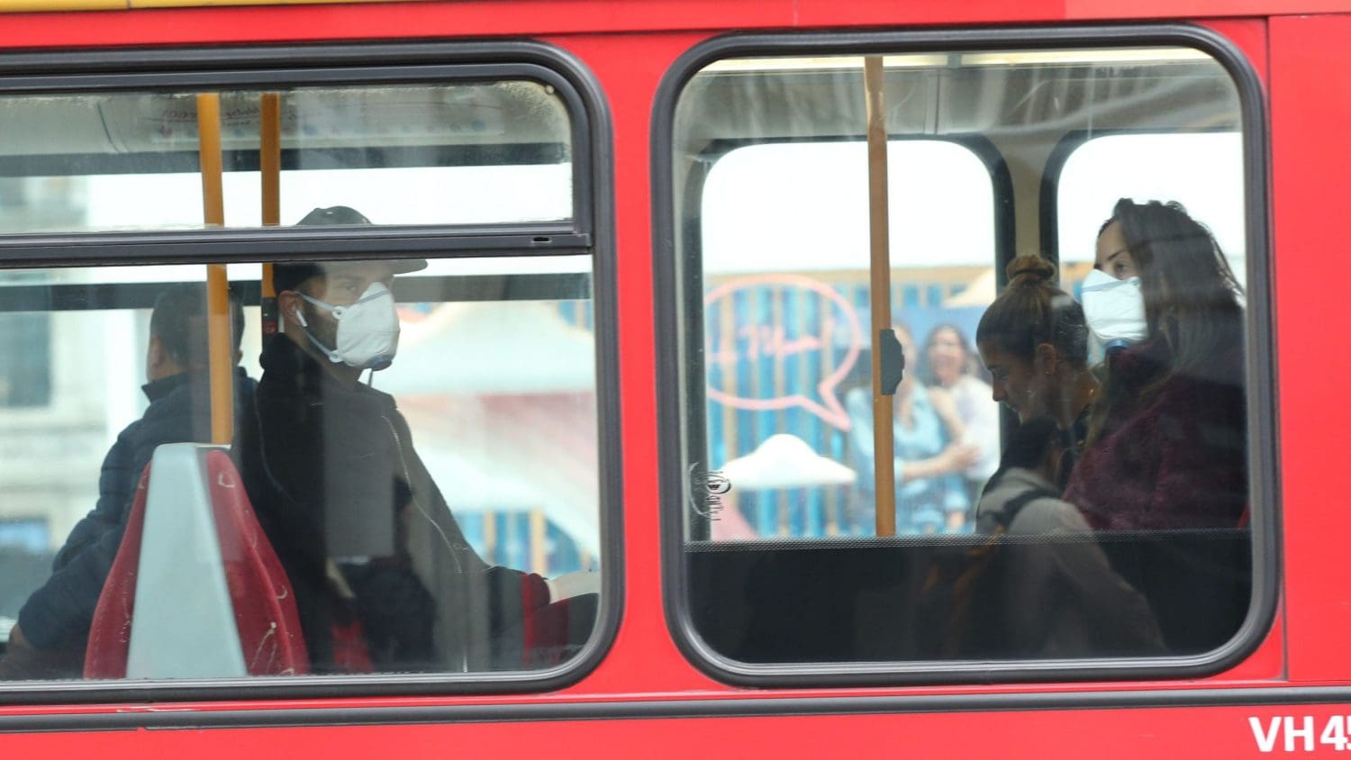 People wearing masks on a bus