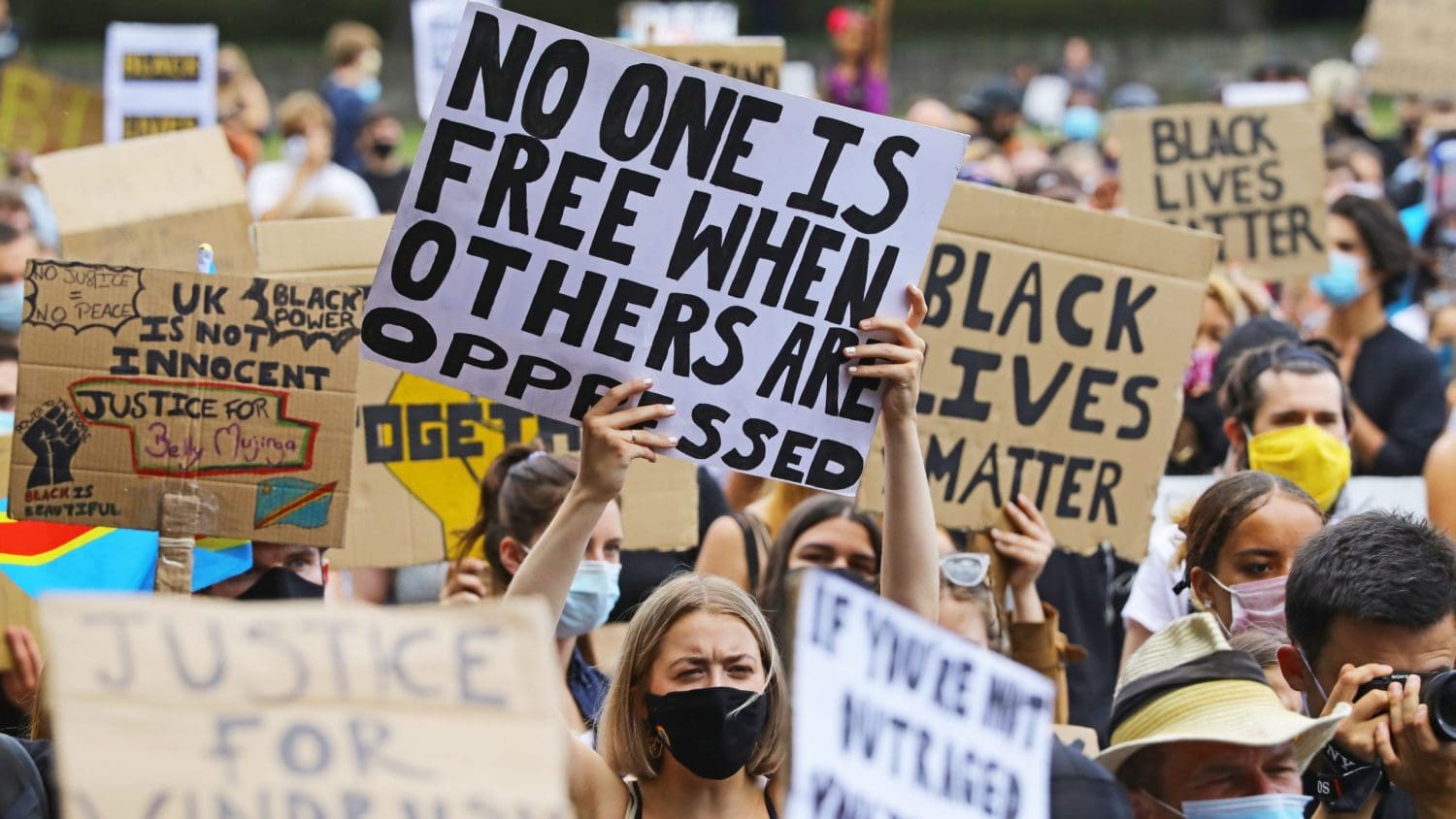 Anti-racism protestors holding up placards