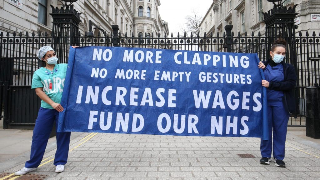 A protest sign which reads 'No more clapping - no more empty gestures - increases wages - fund our NHS'