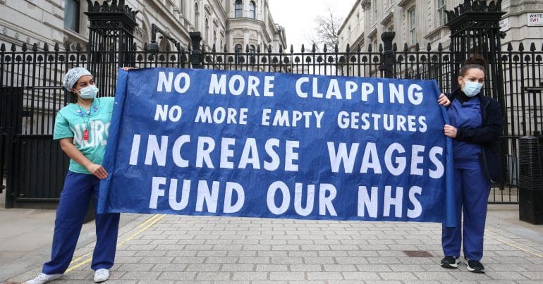A protest sign which reads 'No more clapping - no more empty gestures - increases wages - fund our NHS'