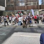 A wide shot of the demo at Labour HQ and Keir Starmer