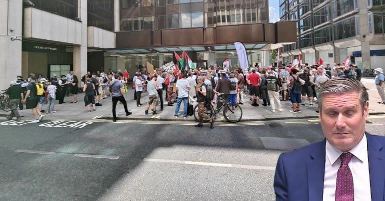 A wide shot of the demo at Labour HQ and Keir Starmer