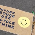 An embroided environmental poster saying refuse, reduce, reuse, recycle and rethink