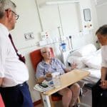 A hospital patient speaking with staff