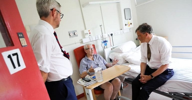 A hospital patient speaking with staff