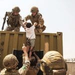 Soldier rescuing a child