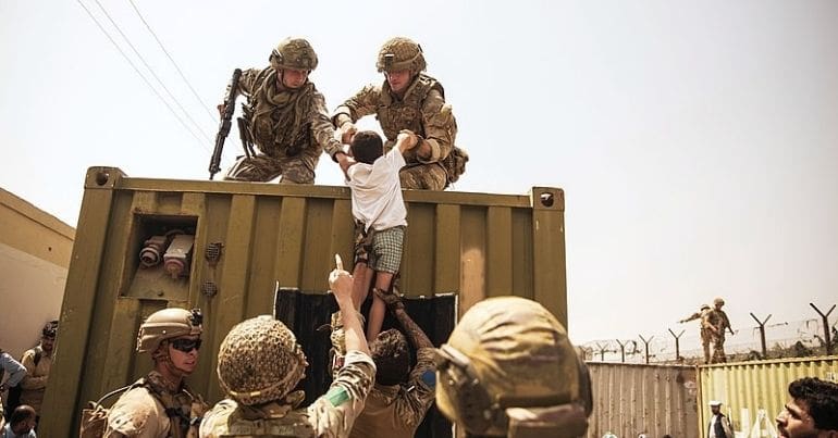 Soldier rescuing a child