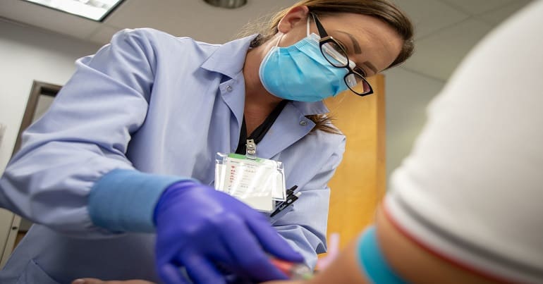 Medical staff injecting a patient