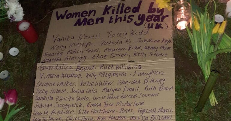 A list of women's names killed by men at a vigil
