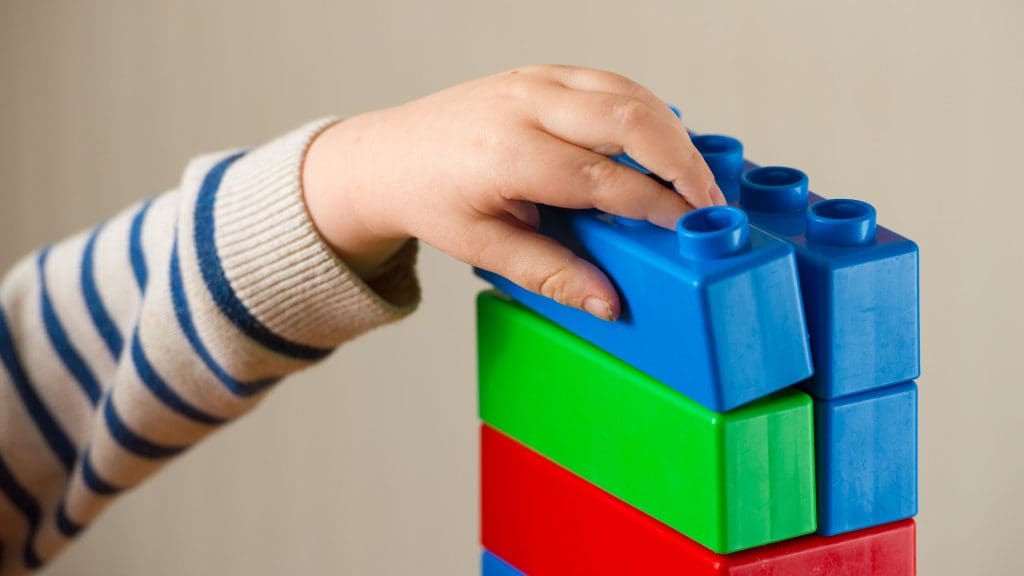 A child playing with toy bricks