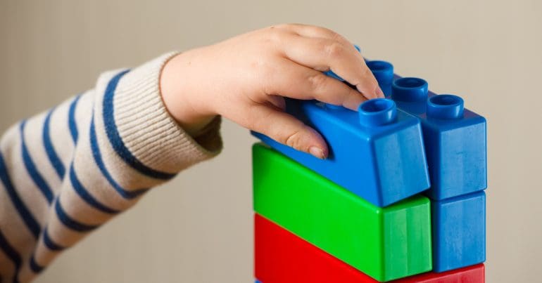 A child playing with toy bricks