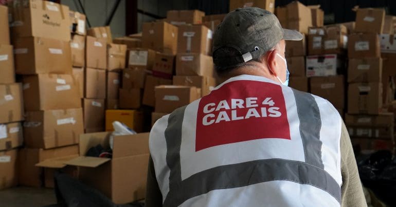 Care 4 Calais workers in a warehouse filled with boxes